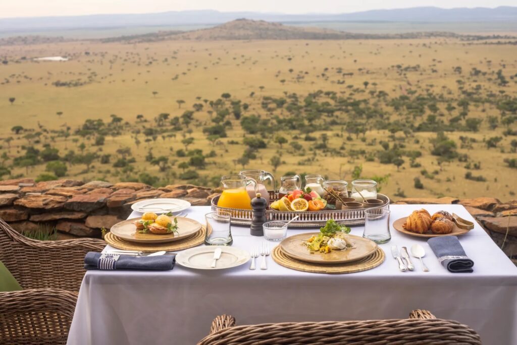 Gourmet dining setup at Sasakwa Luxury Lodge under a star-lit sky