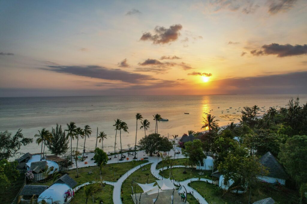 White sandy beach with palm trees in Zanzibar Sunset