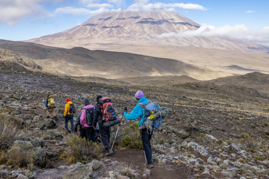 Hikers climbing Mount Kilimanjaro at sunrise